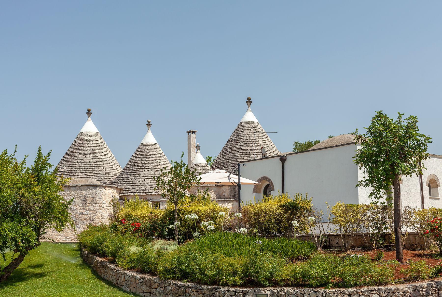 Exterior view of villa and gardens at Trulli Lucia in Puglia