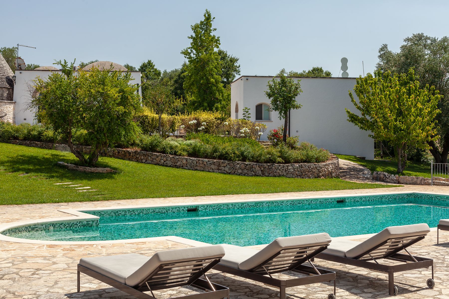 Pool with loungers at Trulli Lucia in Puglia