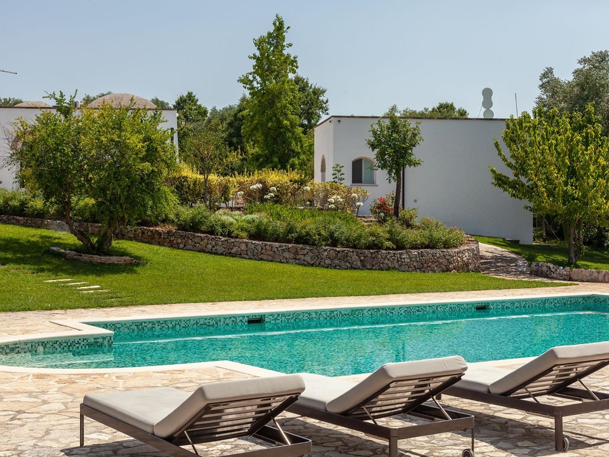 Pool with loungers at Trulli Lucia in Puglia