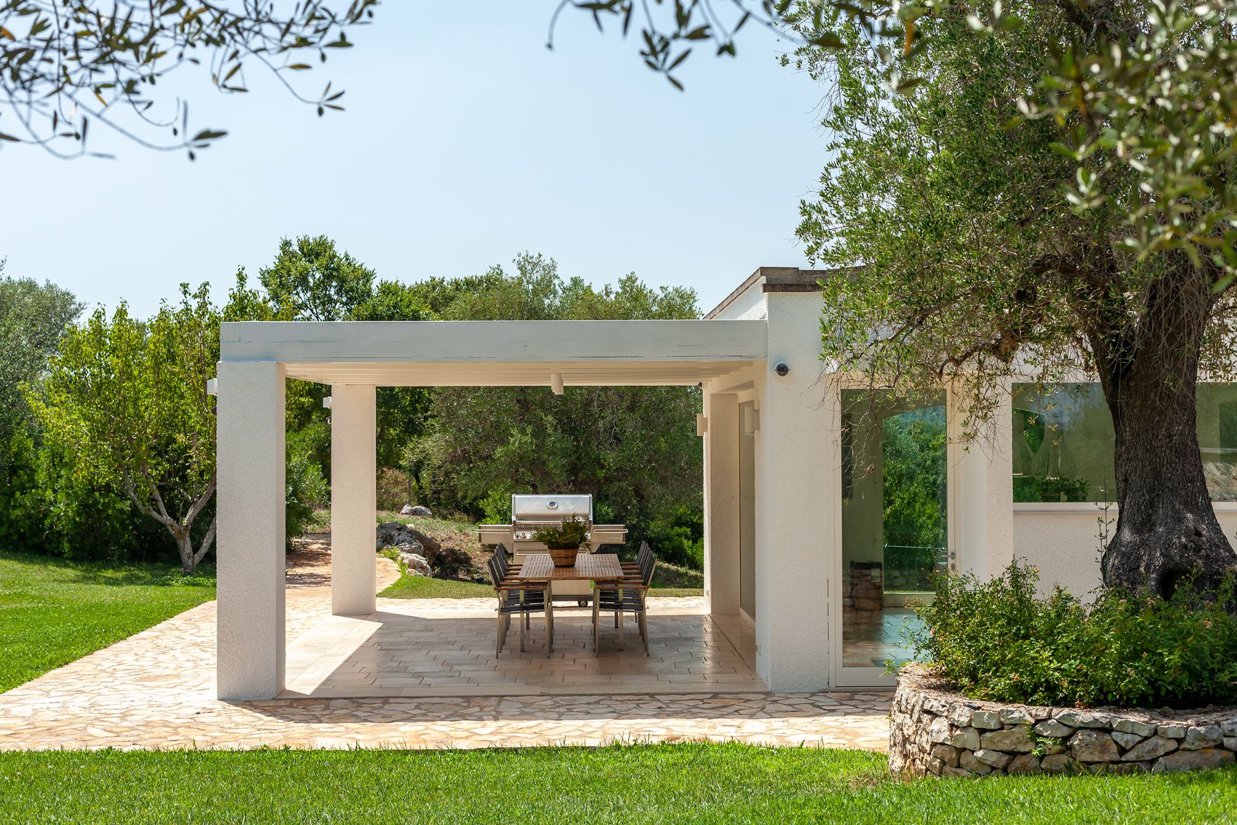 Side view of outdoor kitchen table and patio at Trulli Lucia in Puglia