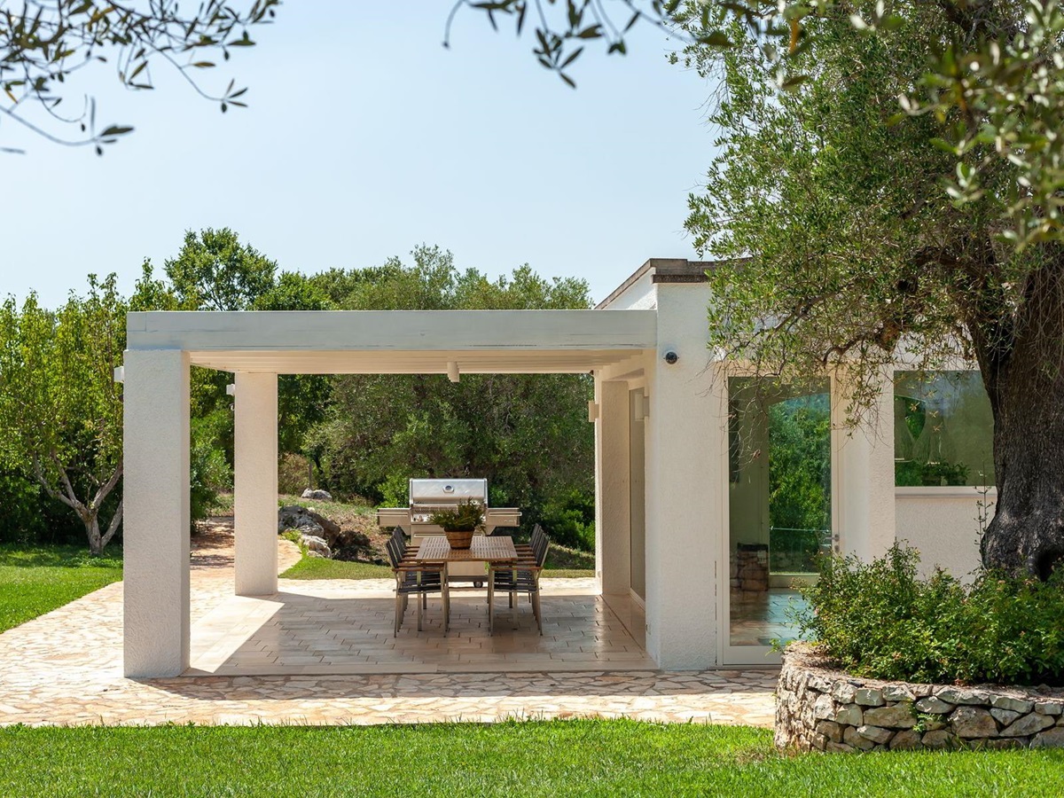 Side view of outdoor kitchen table and patio at Trulli Lucia in Puglia