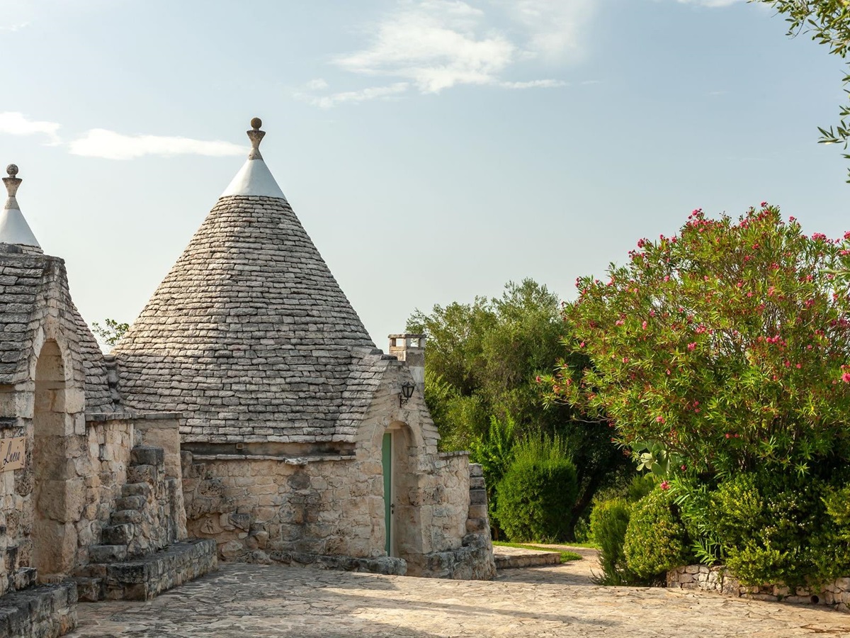 Exterior side view and trees at Trulli Lucia in Puglia