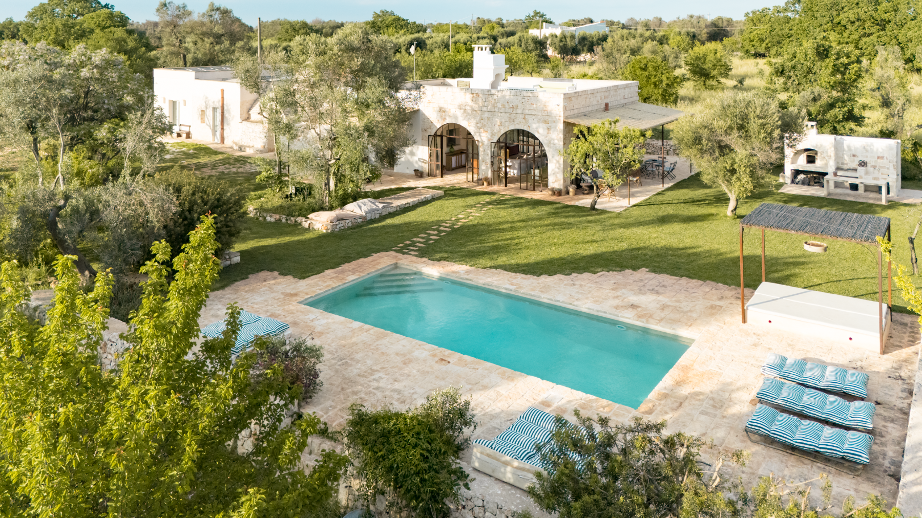 Pool and exterior view of house at Trullo Uliveto, Puglia