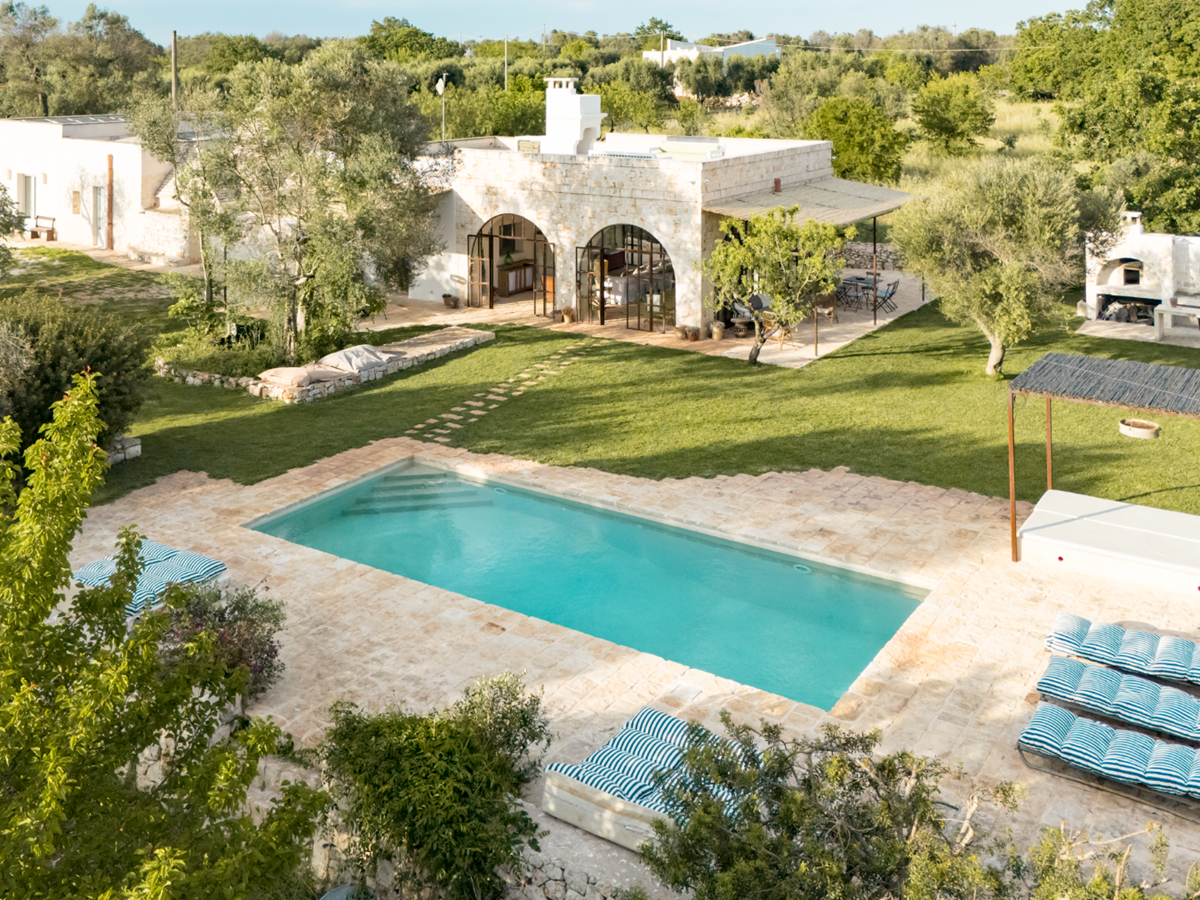 Pool and exterior view of house at Trullo Uliveto, Puglia