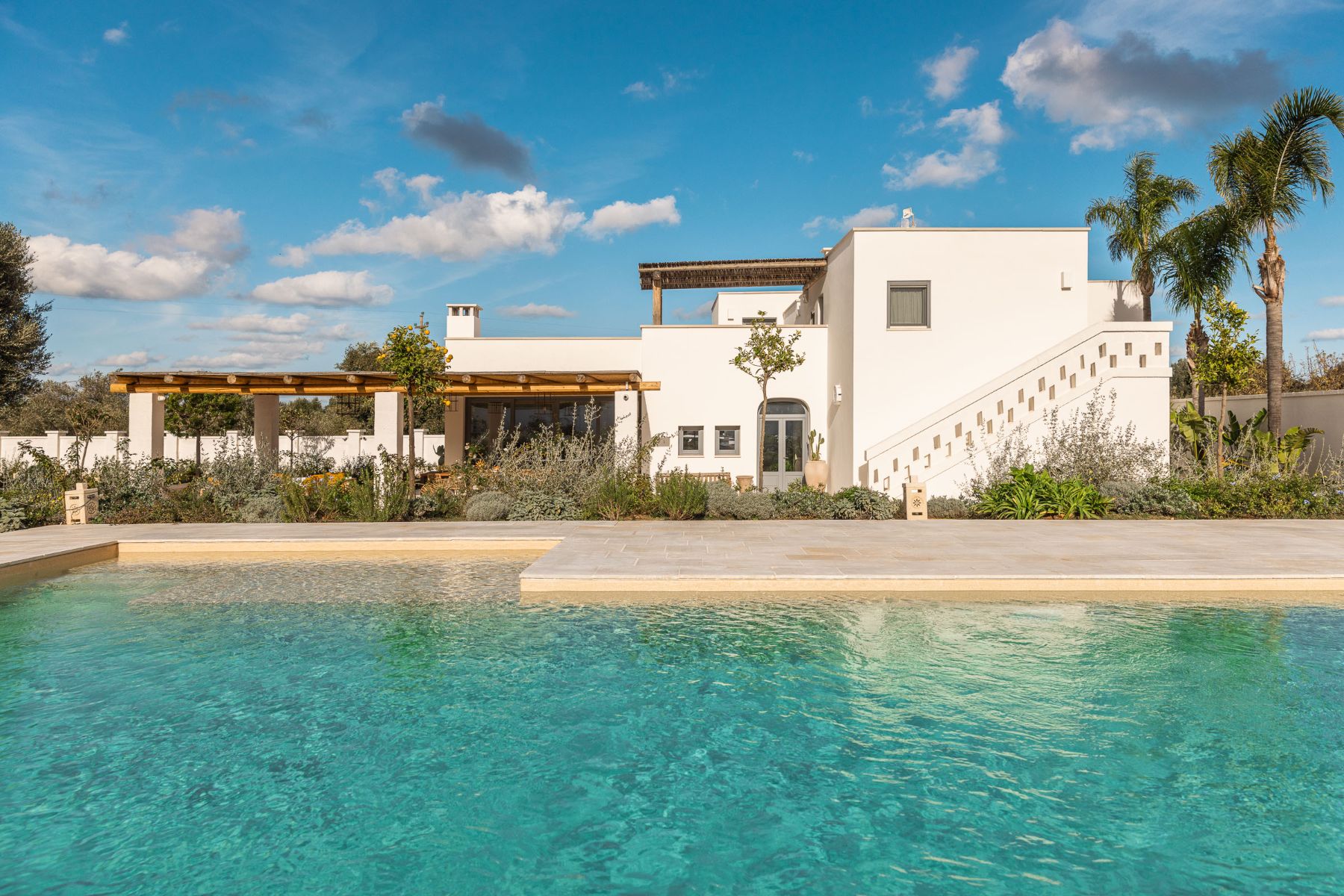 View of the pool and villa at Villa Oliva in Puglia