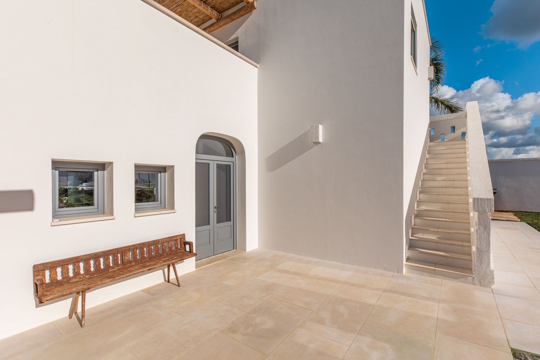 Outdoor patio with views of a bench and stairs at Villa Oliva in Puglia