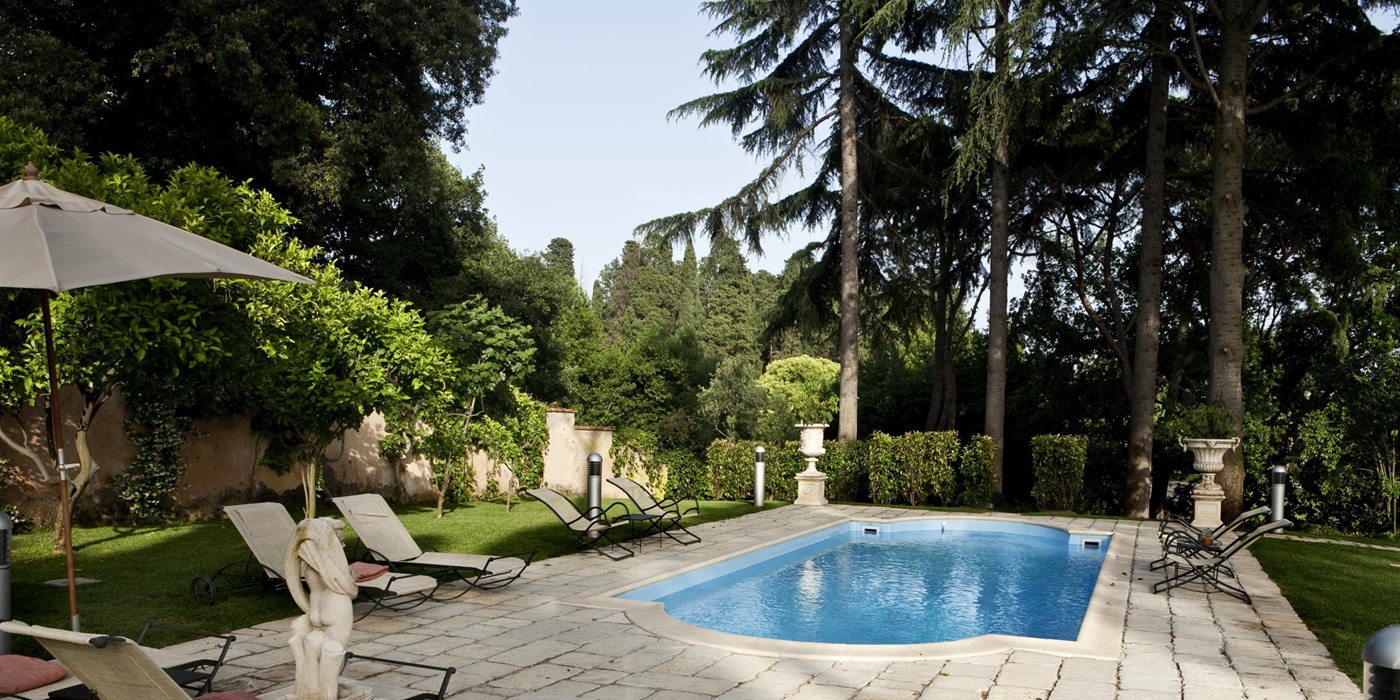 Pool furniture around the swimming pool at Villa Nocetta in the region of Lazio near Rome