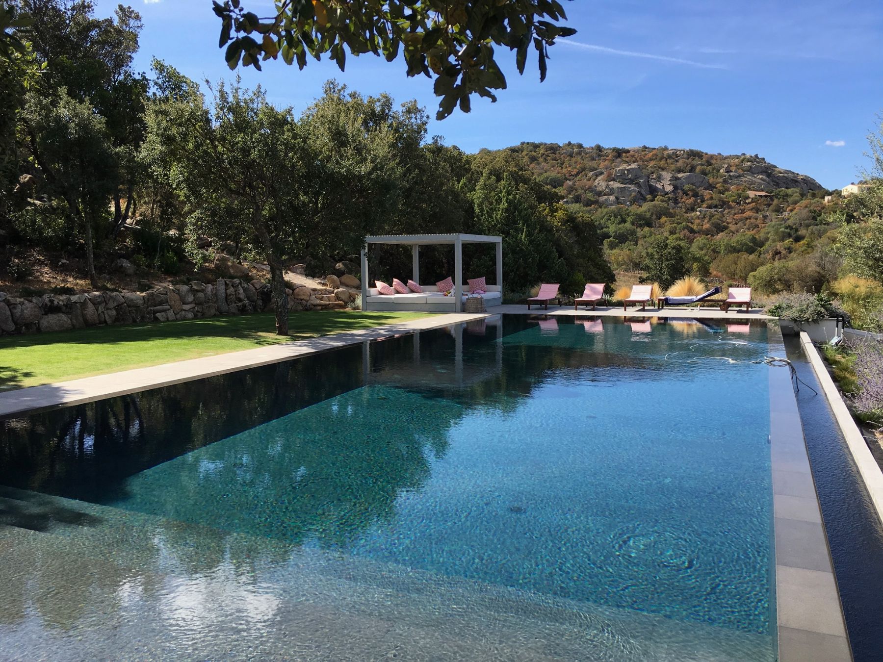 Pool at Il Parrici in Sardinia, with sun beds at the back