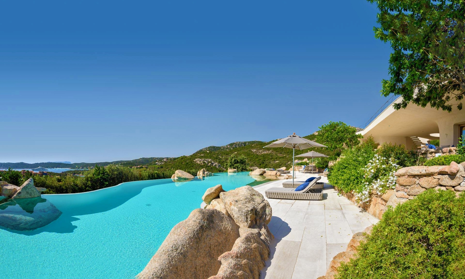 Large pool with loungers and sea views at The Rock, luxury villa in Sardinia