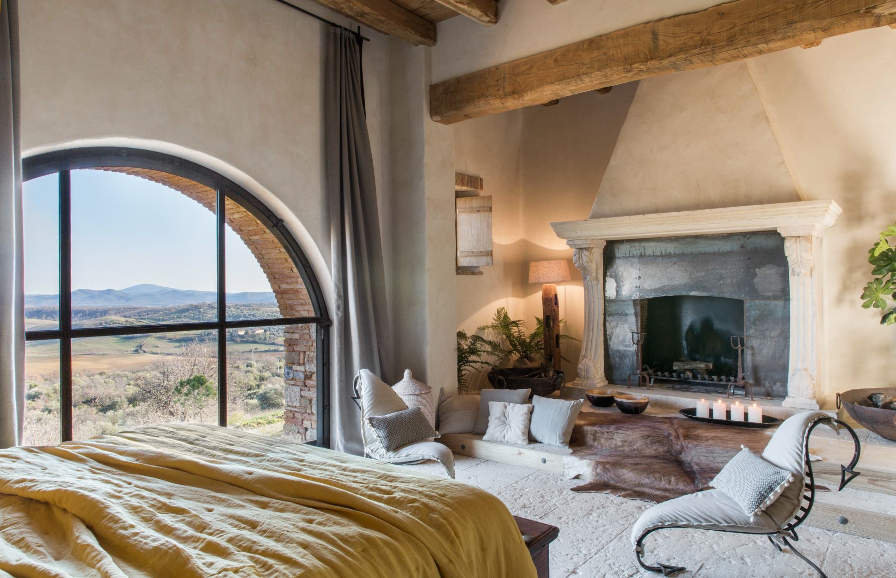 Bedroom with fireplace at Borgo Rinato in Tuscany