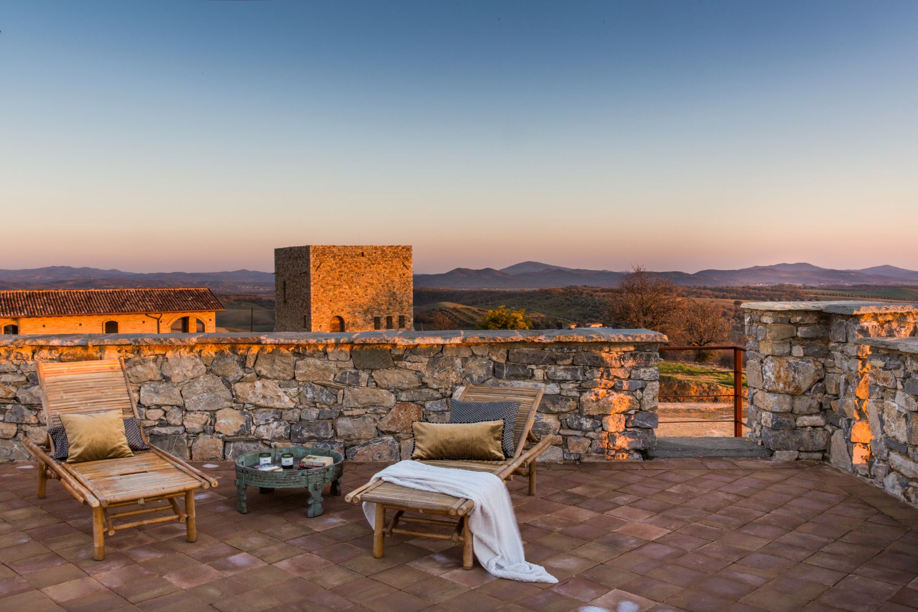 Rooftop loungers and view at Borgo Rinato in Tuscany