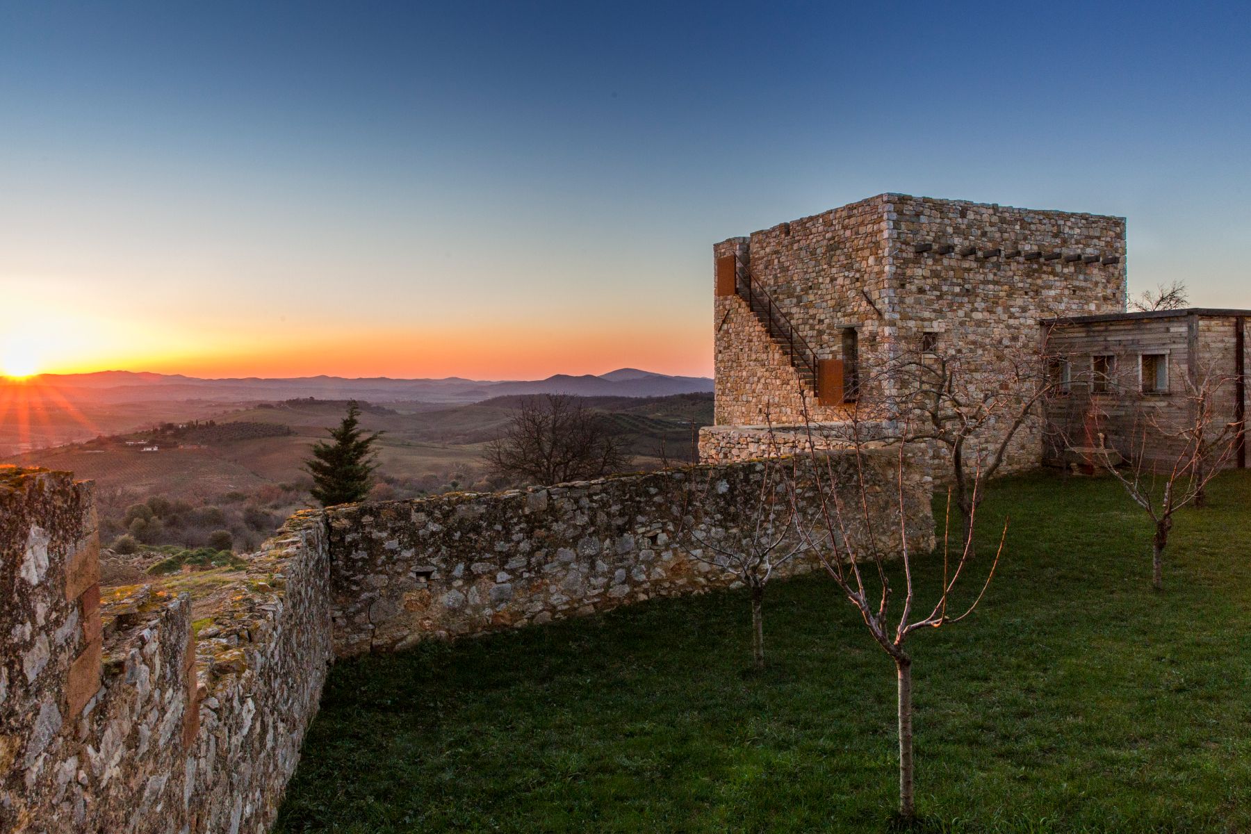 Exterior stone walls and view at Borgo Rinato in Tuscany