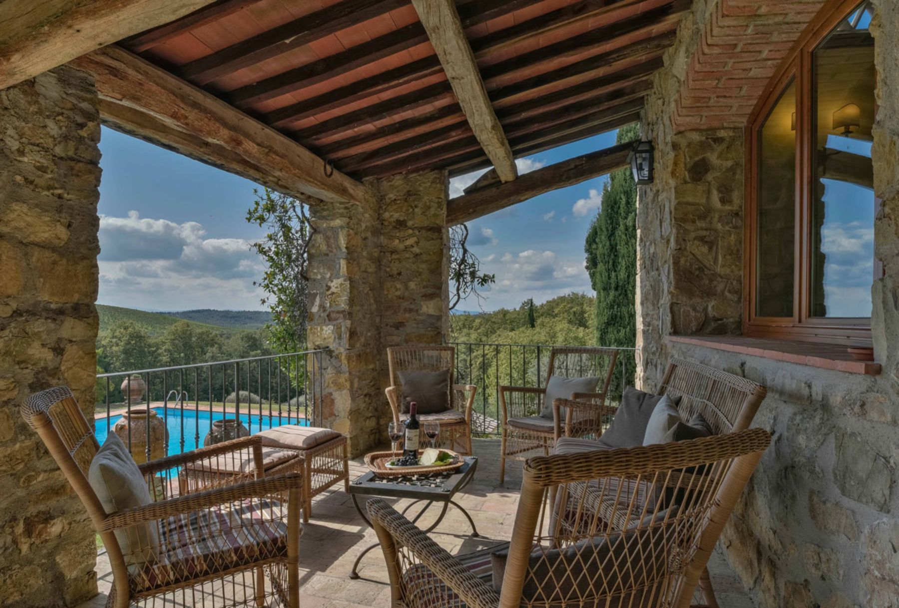 Balcony seating with pool view at Casa Picchio in Tuscany