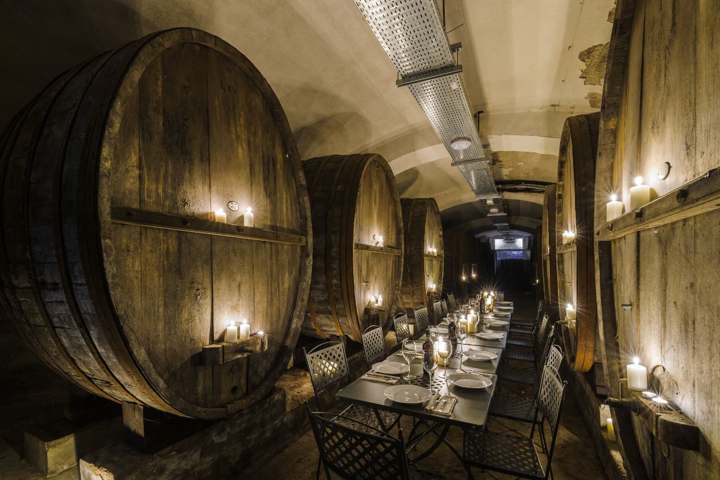 Dining area amongst the wine barrels of Castello San Lorenzo.