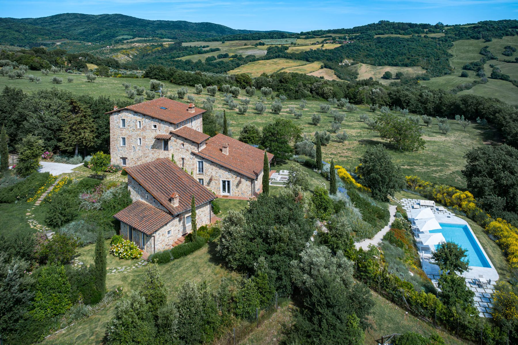 Drone view of Villa Il Mugnello in Tuscany with view of the hills and pool
