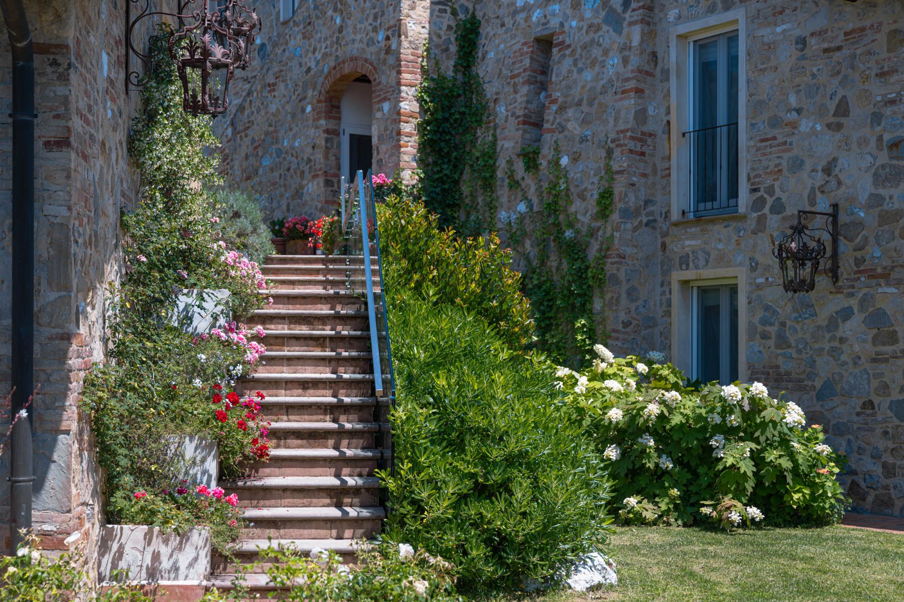 Outdoor stairs in the garden at Villa Il Mugnello in Tuscany surrounded by flowers