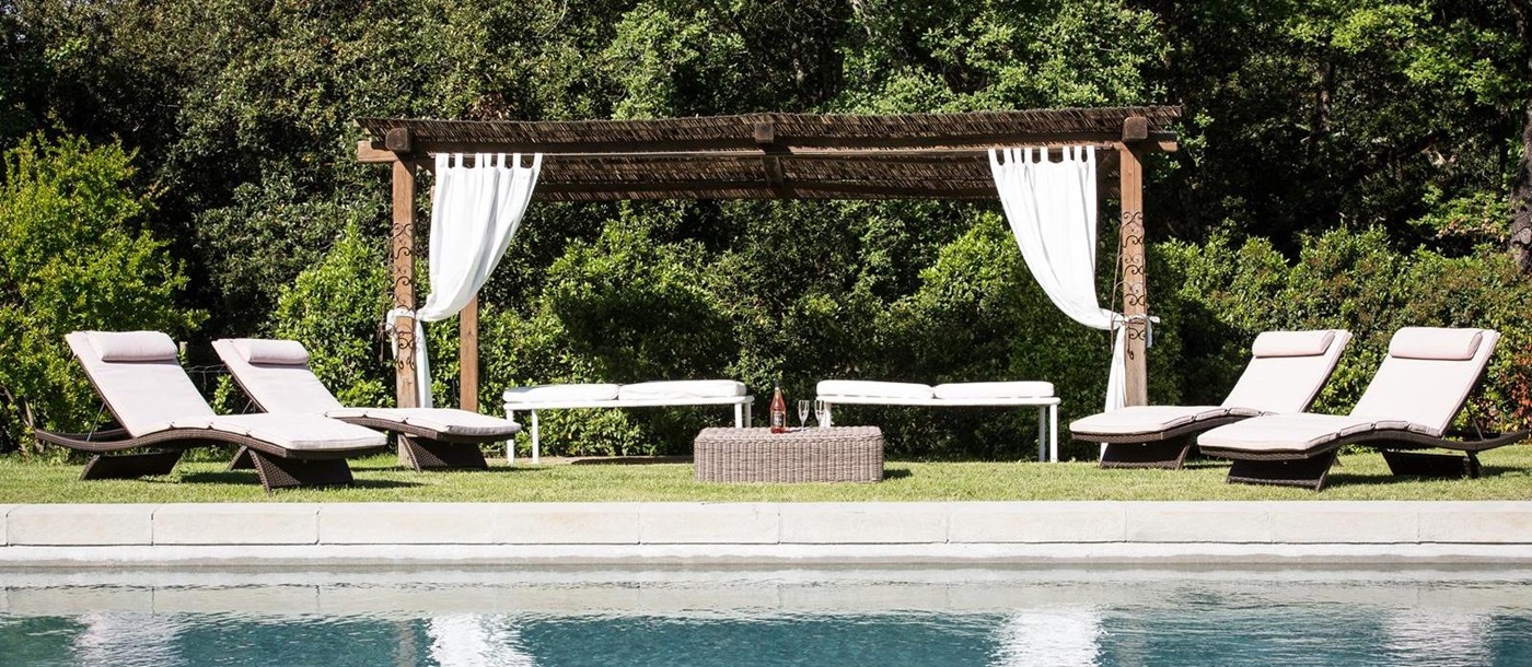 The swimming pool with sunloungers at Il Prato di Vignamaggio, Chianti, Tuscany