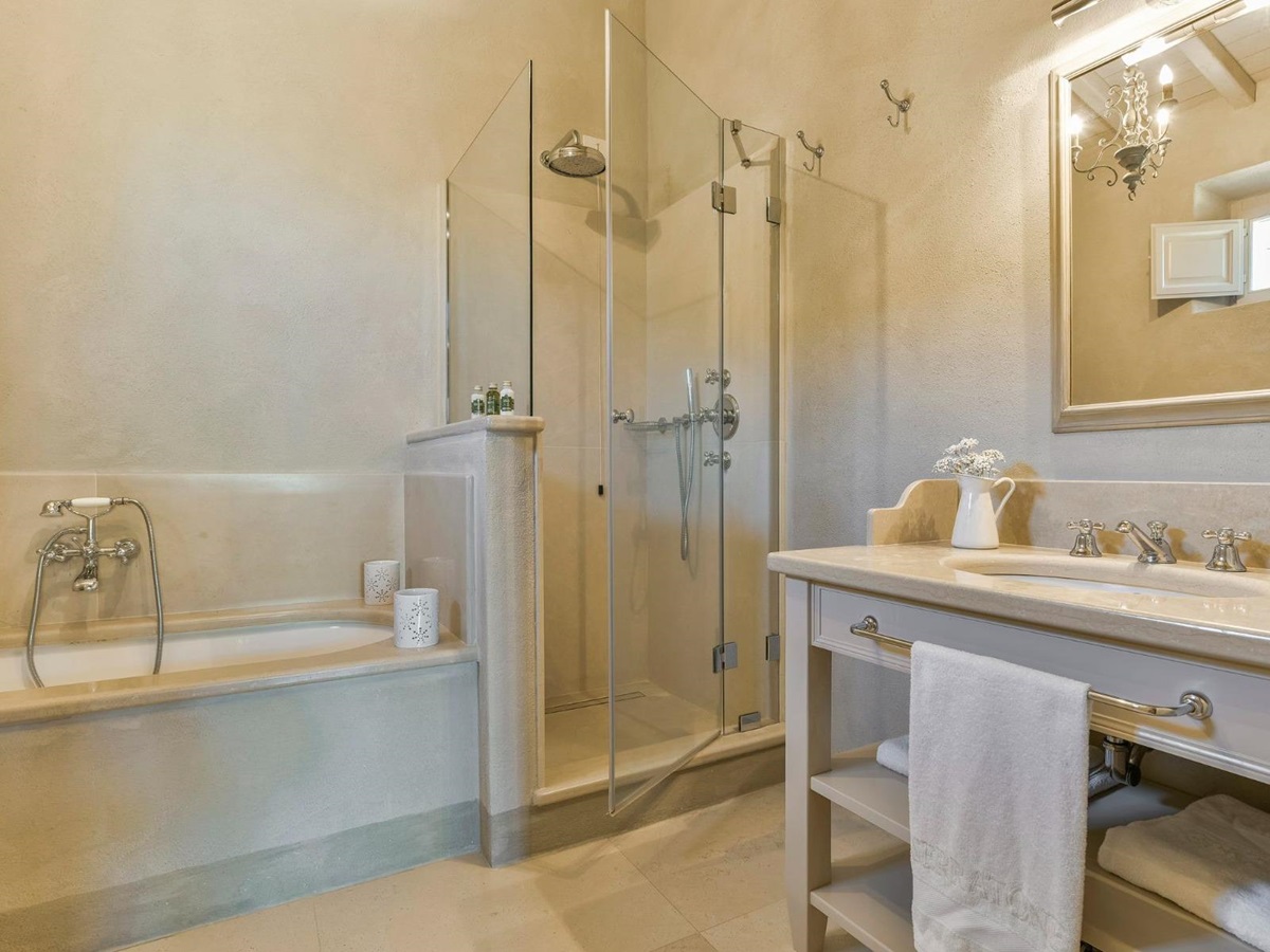 bathroom with bath, shower and basin at Villa Il Serratone in Tuscany