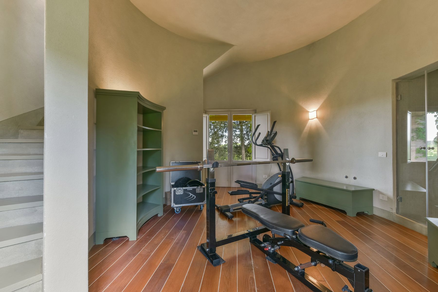 gym with two equipments such as cross trainer in the silo at villa Il Serratone in Tuscany