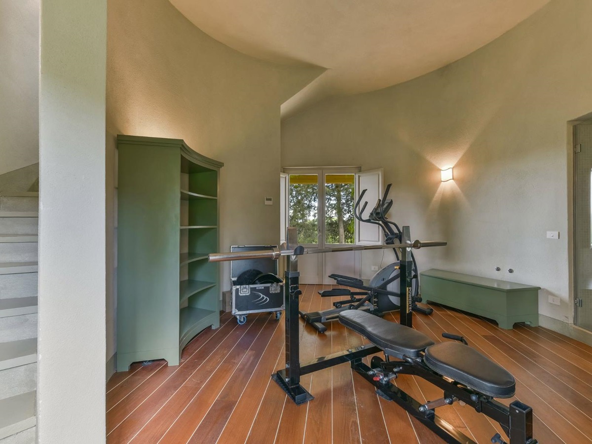 gym with two equipments such as cross trainer in the silo at villa Il Serratone in Tuscany