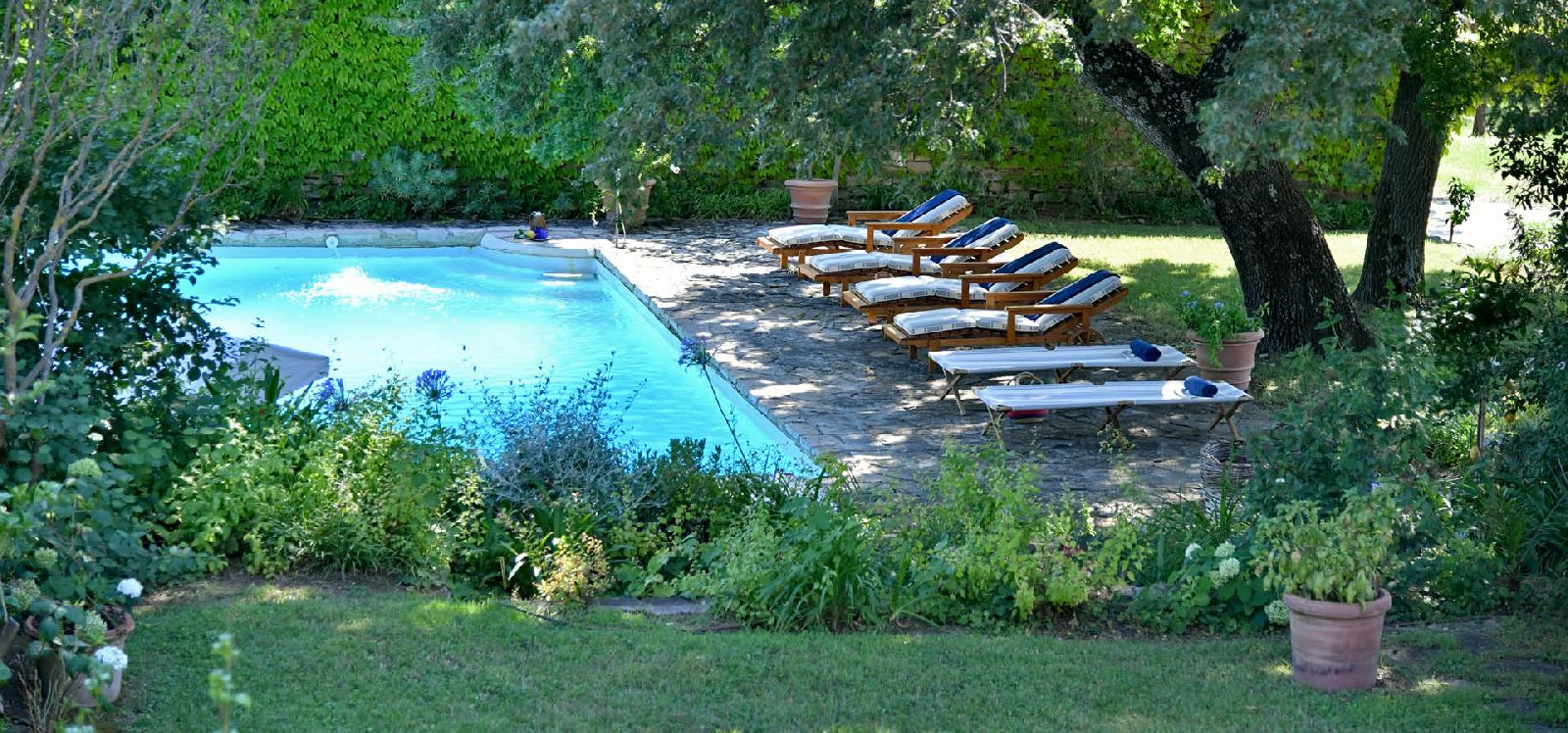 The swimming pool and gardens of villa La Civetta in Tuscany