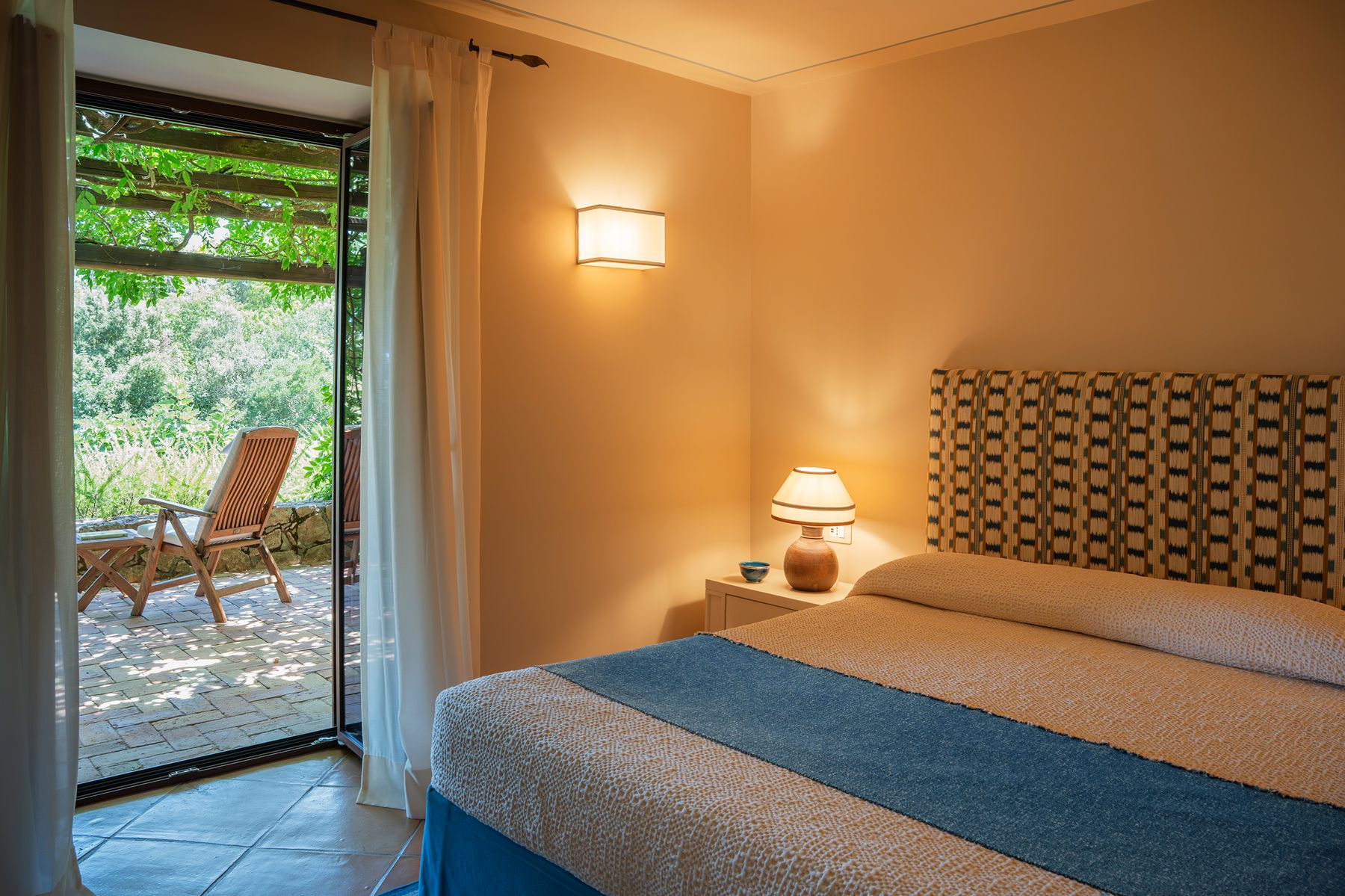 Bedroom and Patio at La Feniglia