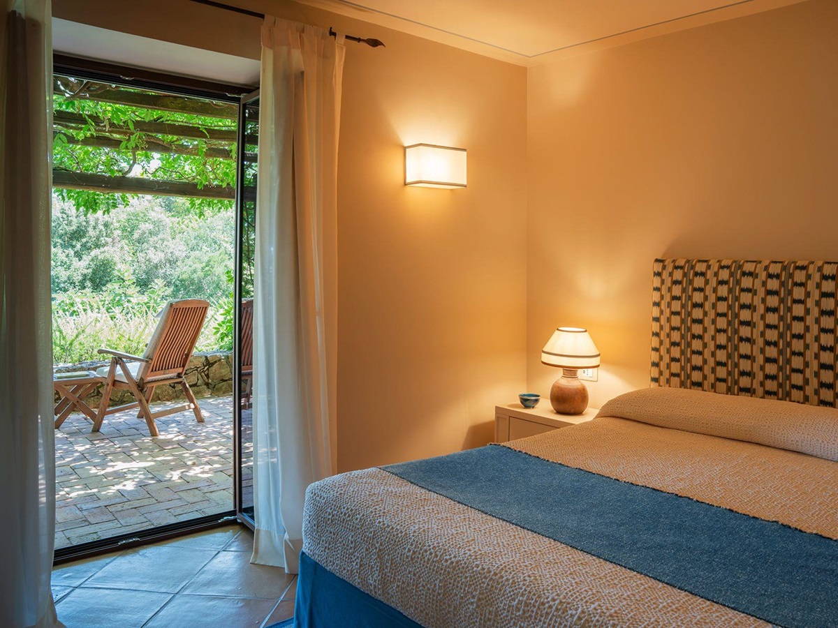 Bedroom and Patio at La Feniglia