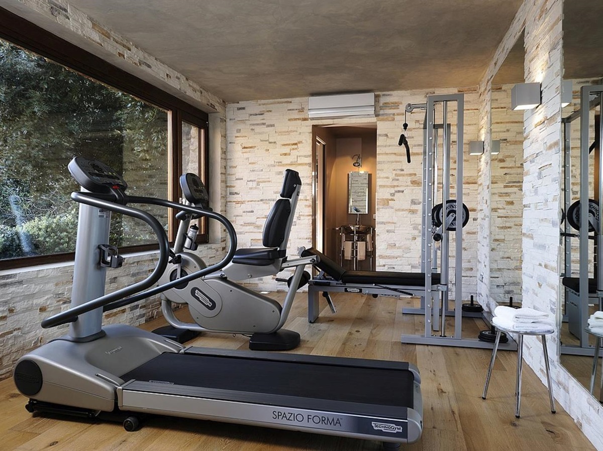 Gym with equipment and large windows at La Feniglia in Porto Ercole in Tuscany
