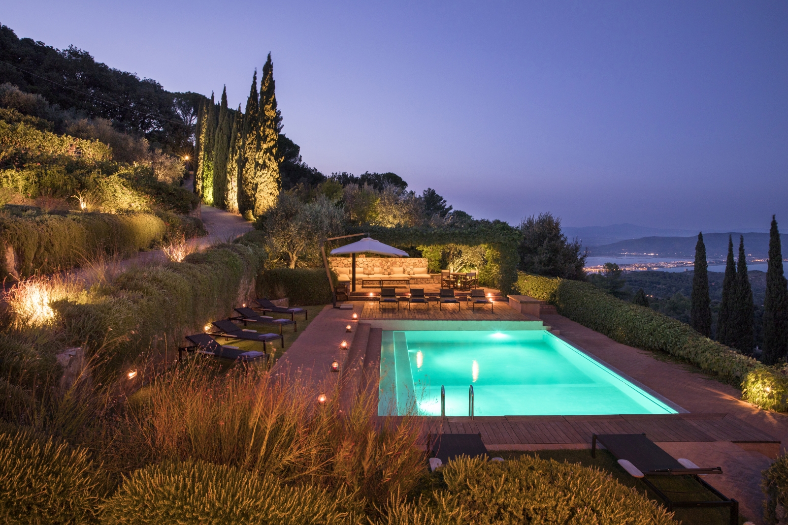 Pool area and sea view at night at La Feniglia in Porto Ercole in Tuscany