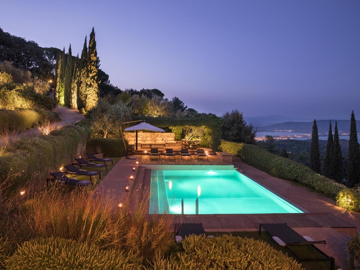 Pool area and sea view at night at La Feniglia in Porto Ercole in Tuscany