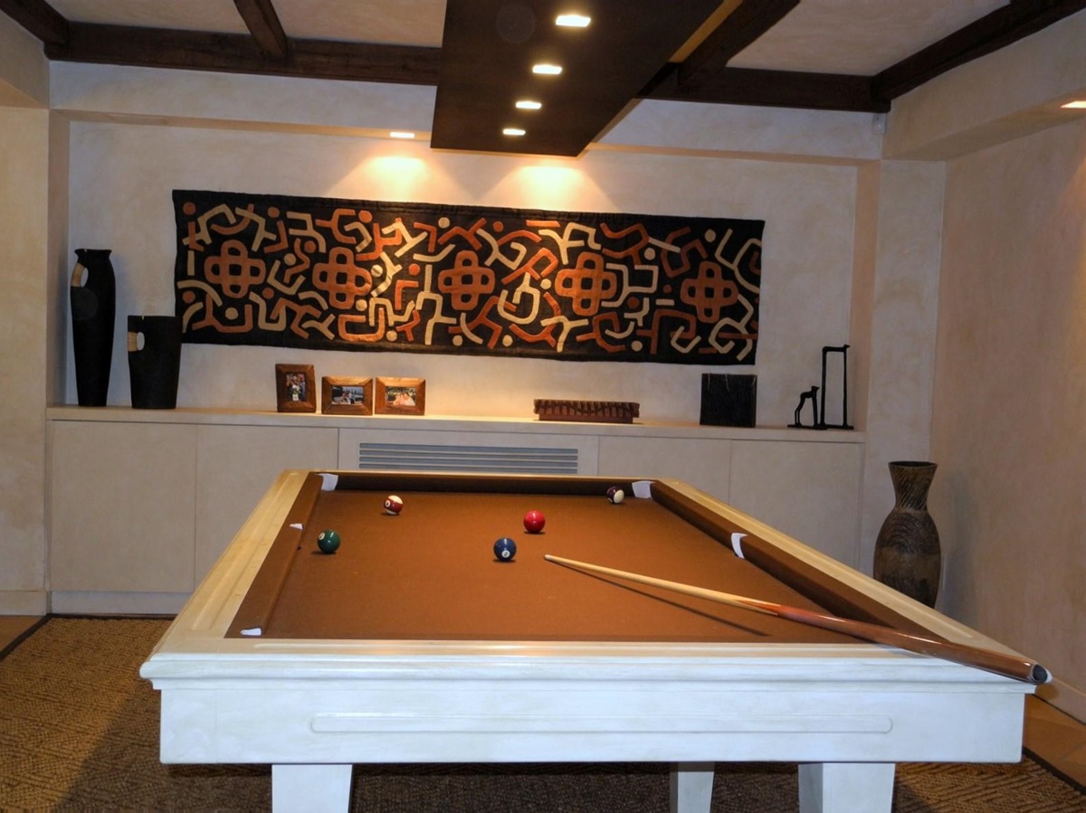 Games room with pool table and tribal style decorations at La Feniglia in Porto Ercole in Tuscany