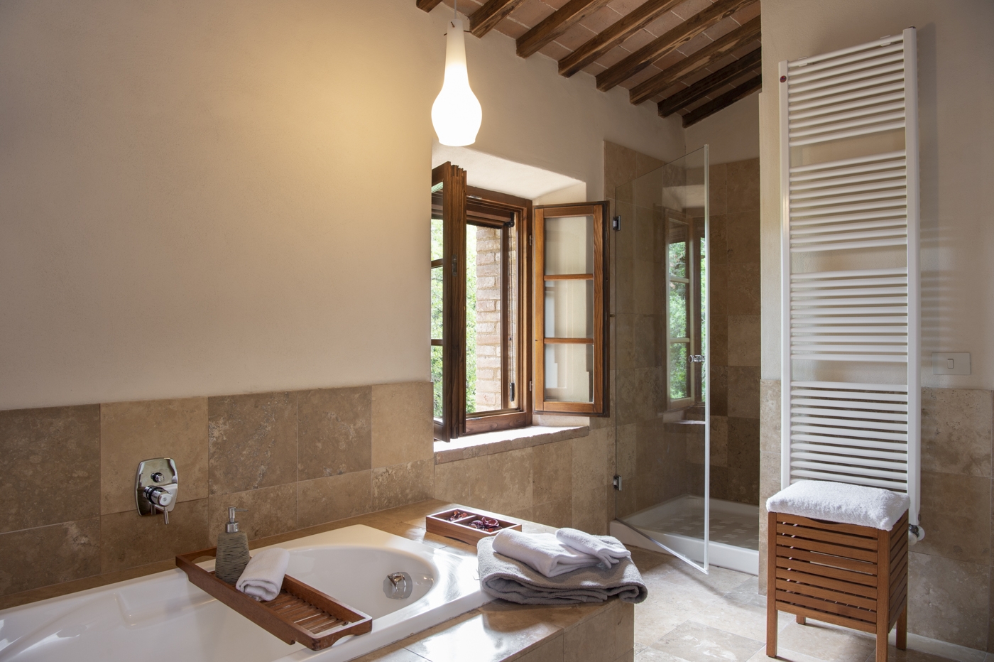 Bathroom with bath, towel rail and shower at La Gavelli in Tuscany, Italy