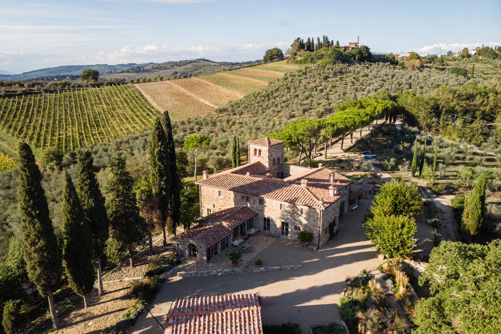 Aerial view of villa, driveway and surrounding countryside at La Regina in Tuscany, Italy