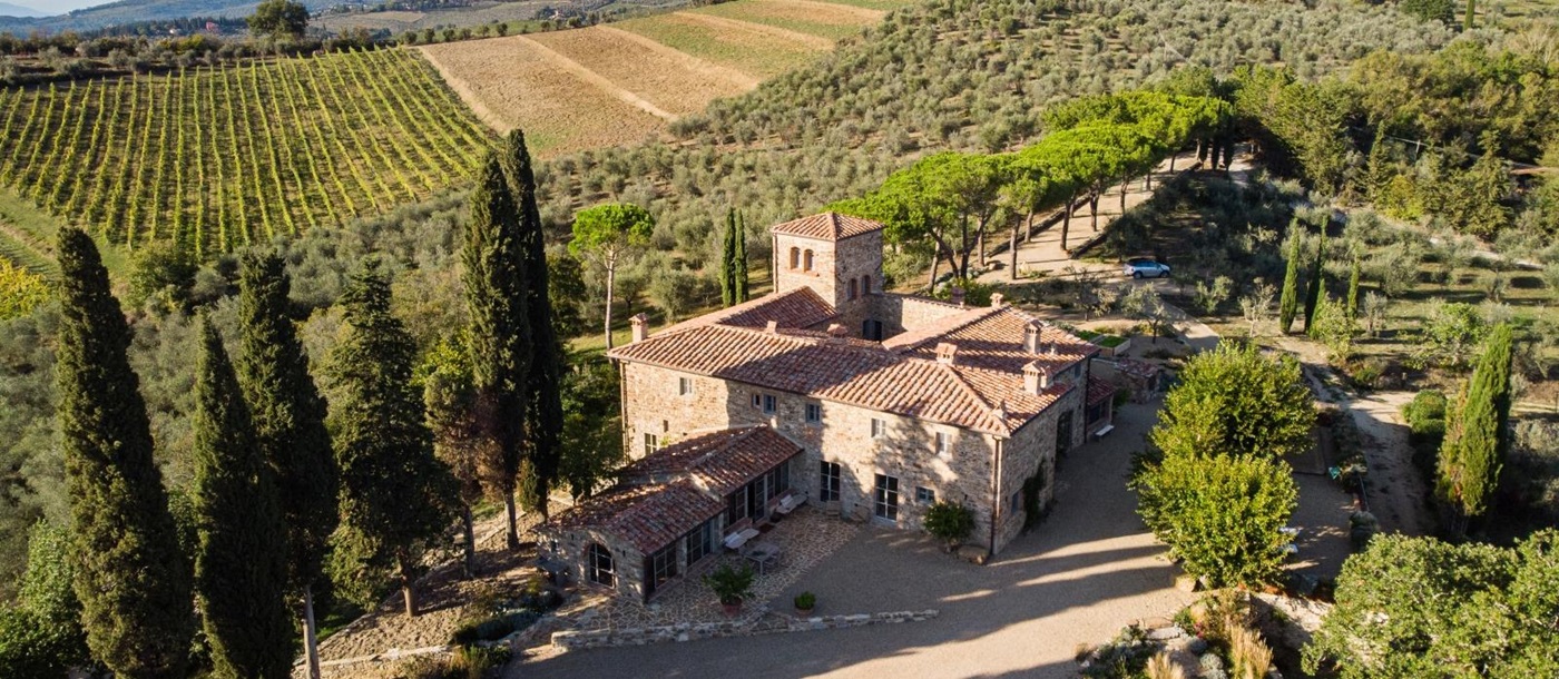 Aerial view of villa, driveway and surrounding countryside at La Regina in Tuscany, Italy