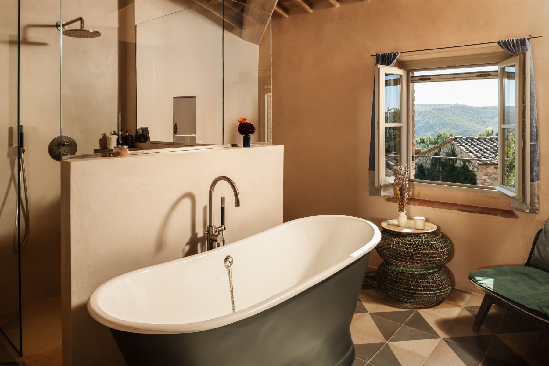 Bathroom with a shower and a large bath tub at La Regina in Tuscany
