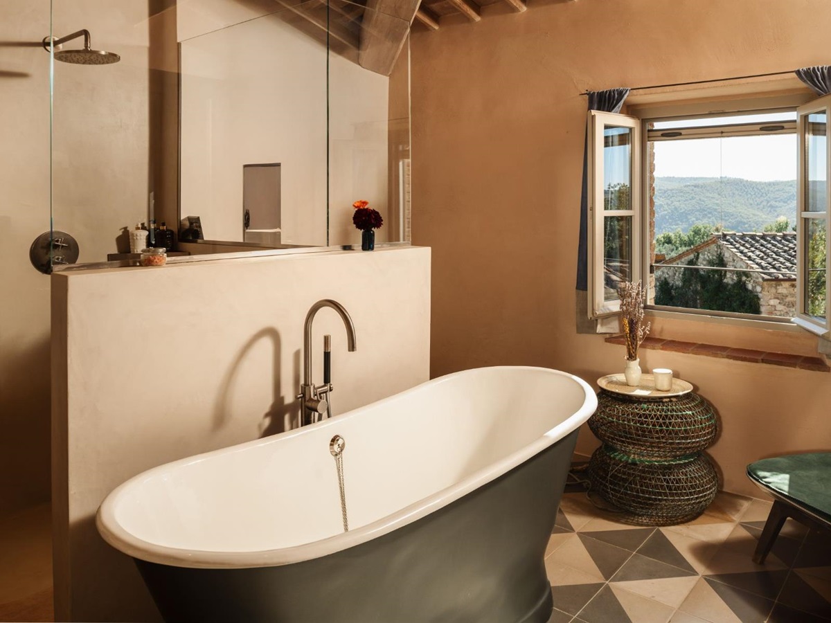 Bathroom with a shower and a large bath tub at La Regina in Tuscany