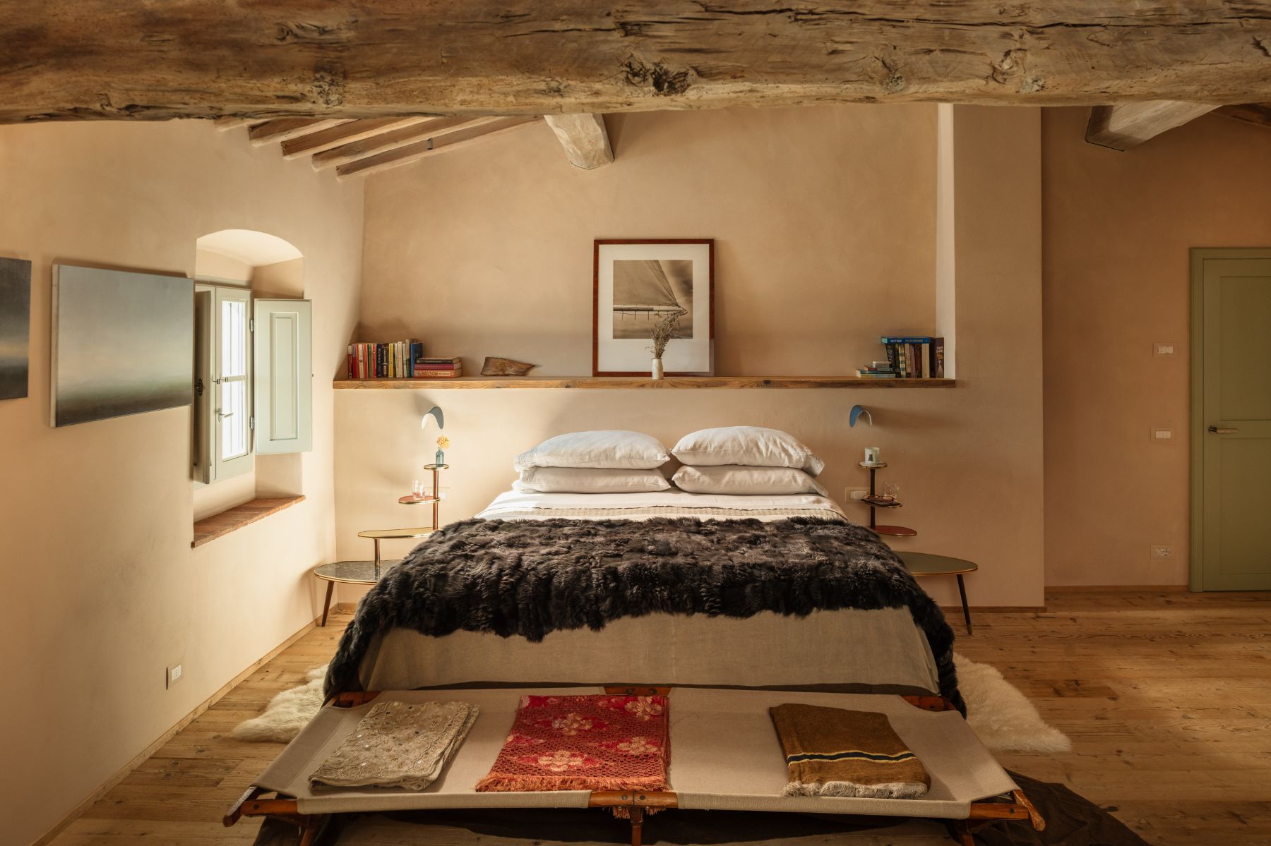 Large double bedroom with wooden floors and a window with shutters at La Regina in Tuscany