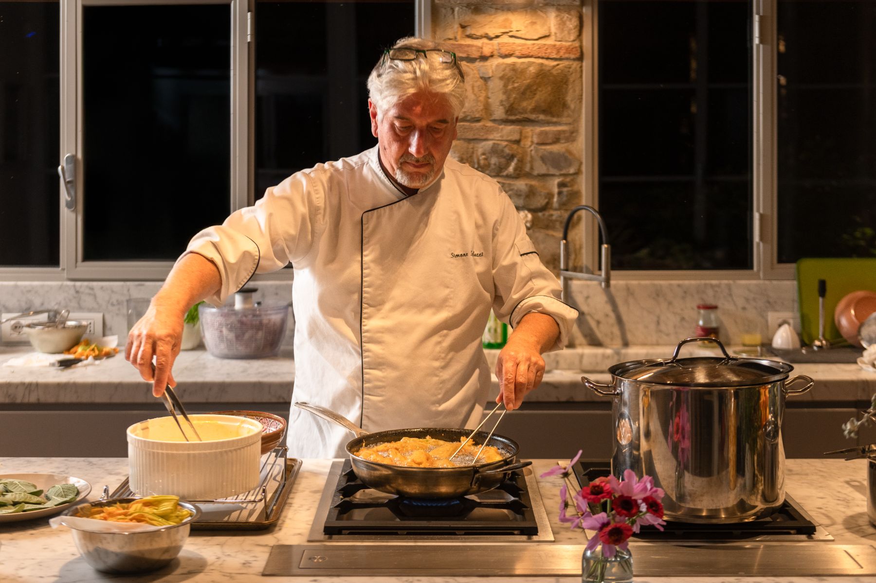 Chef in the kitchen at La Regina in Tuscany cooking food