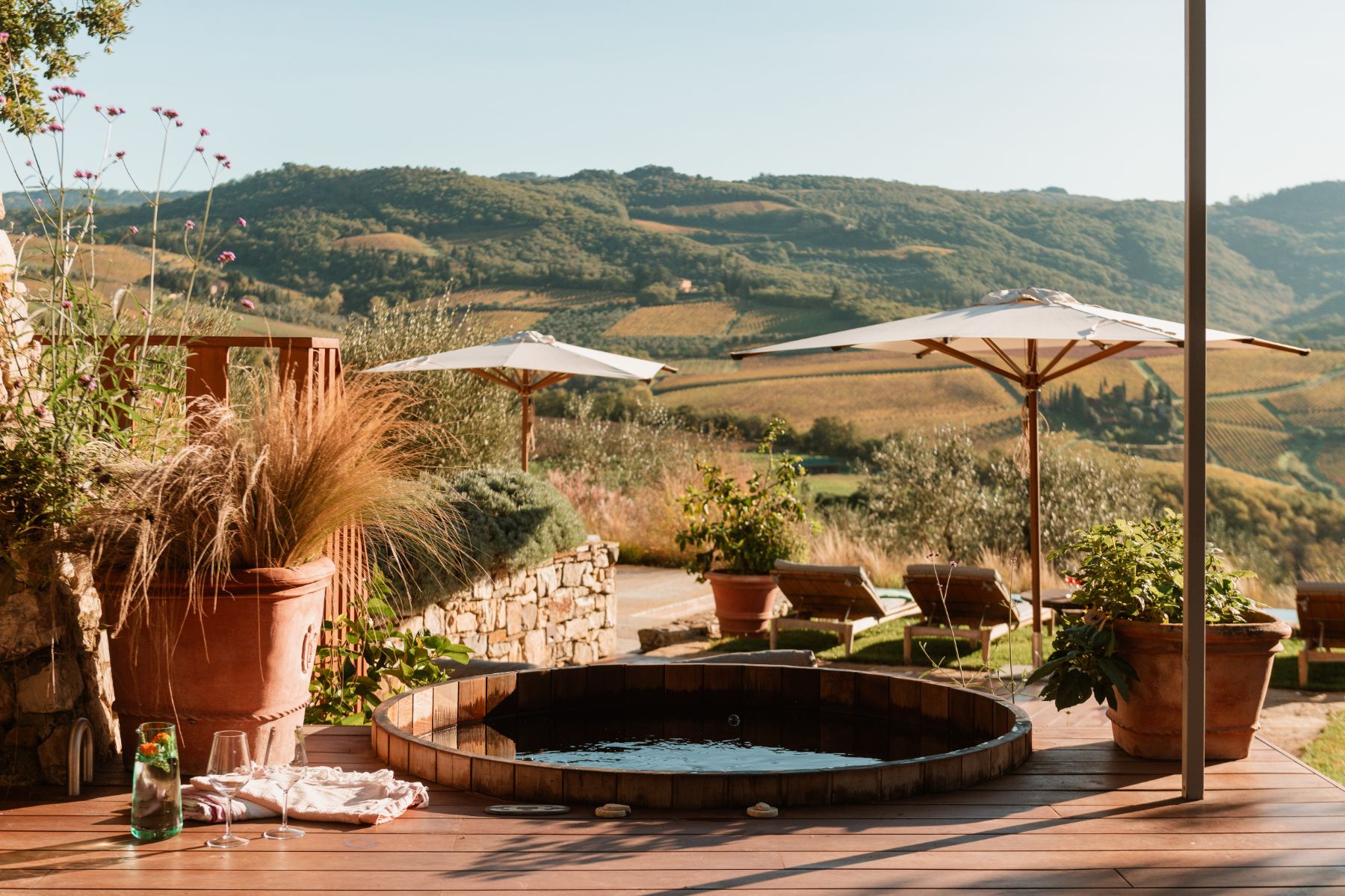 Outdoor hot tub overlooking the pool area at La Regina in Tuscany