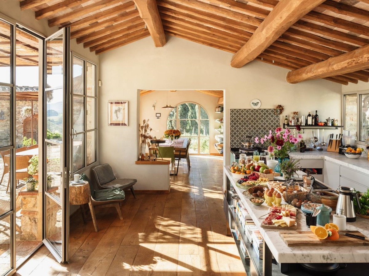 Kitchen area with view of the indoor dining room and the outdoor area at La Regina in Tuscany