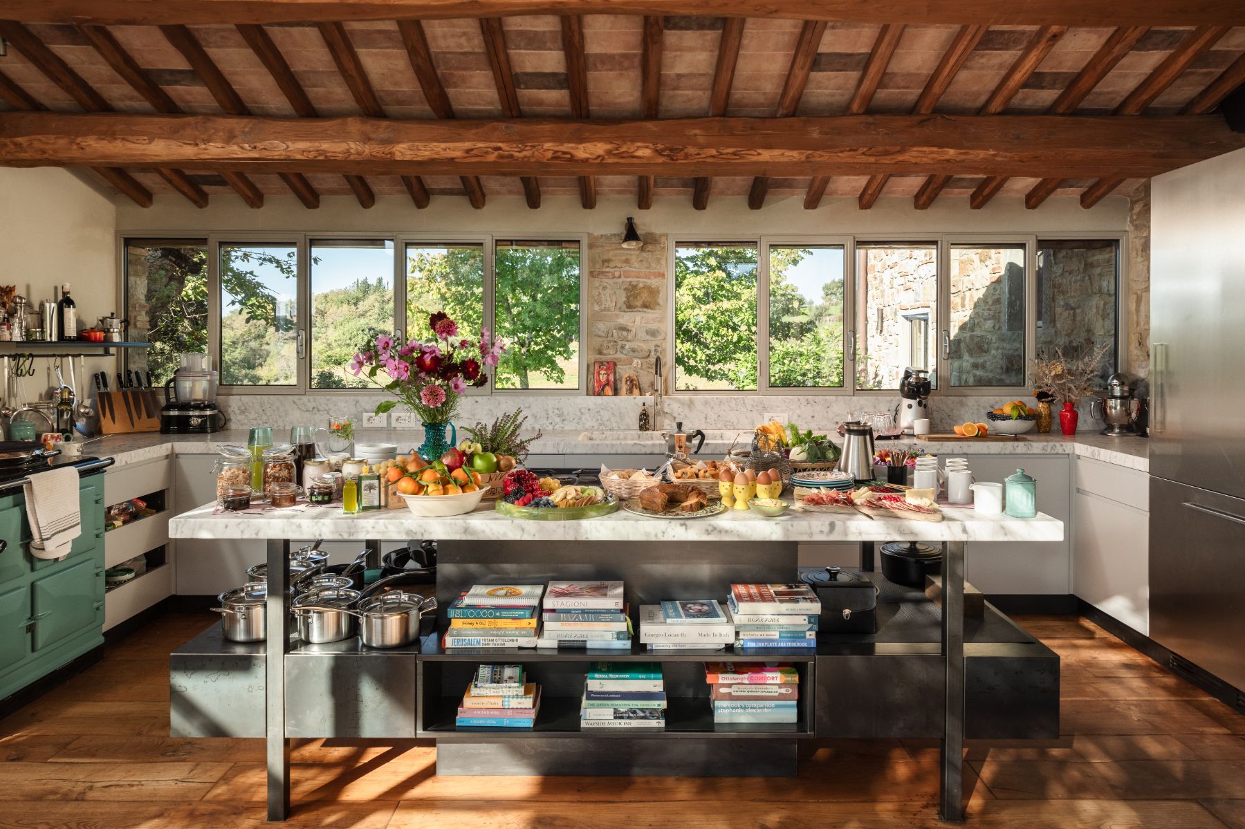 Kitchen with a marble island with groceries at La Regina in Tuscany