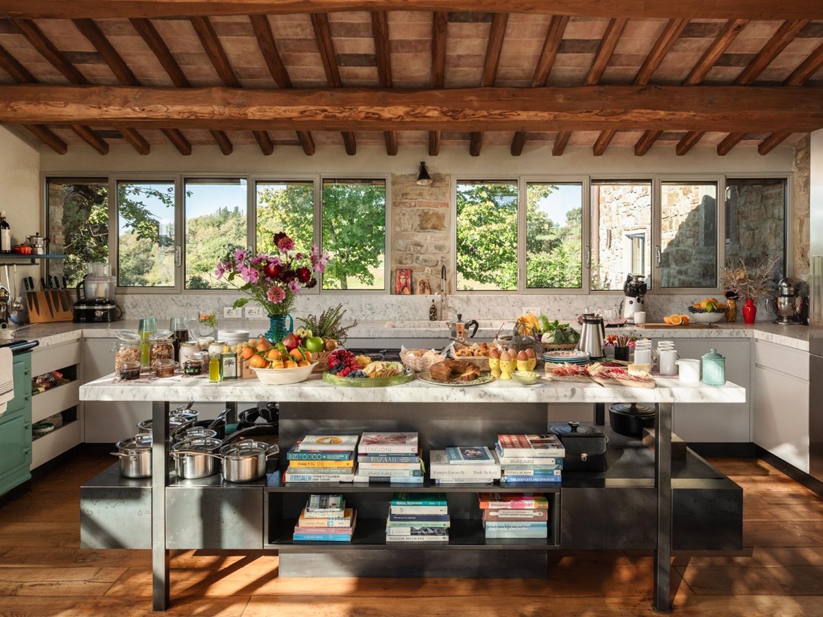Kitchen with a marble island with groceries at La Regina in Tuscany