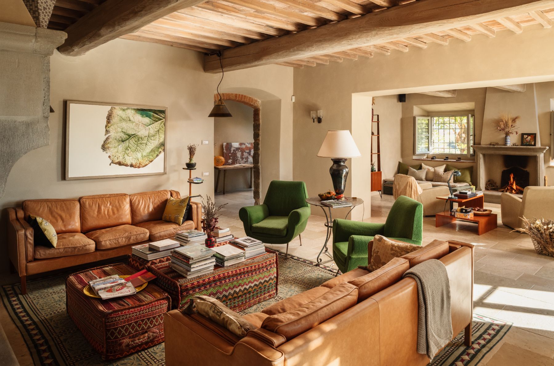 Living room with brown sofas and green armchairs at La Regina in Tuscany