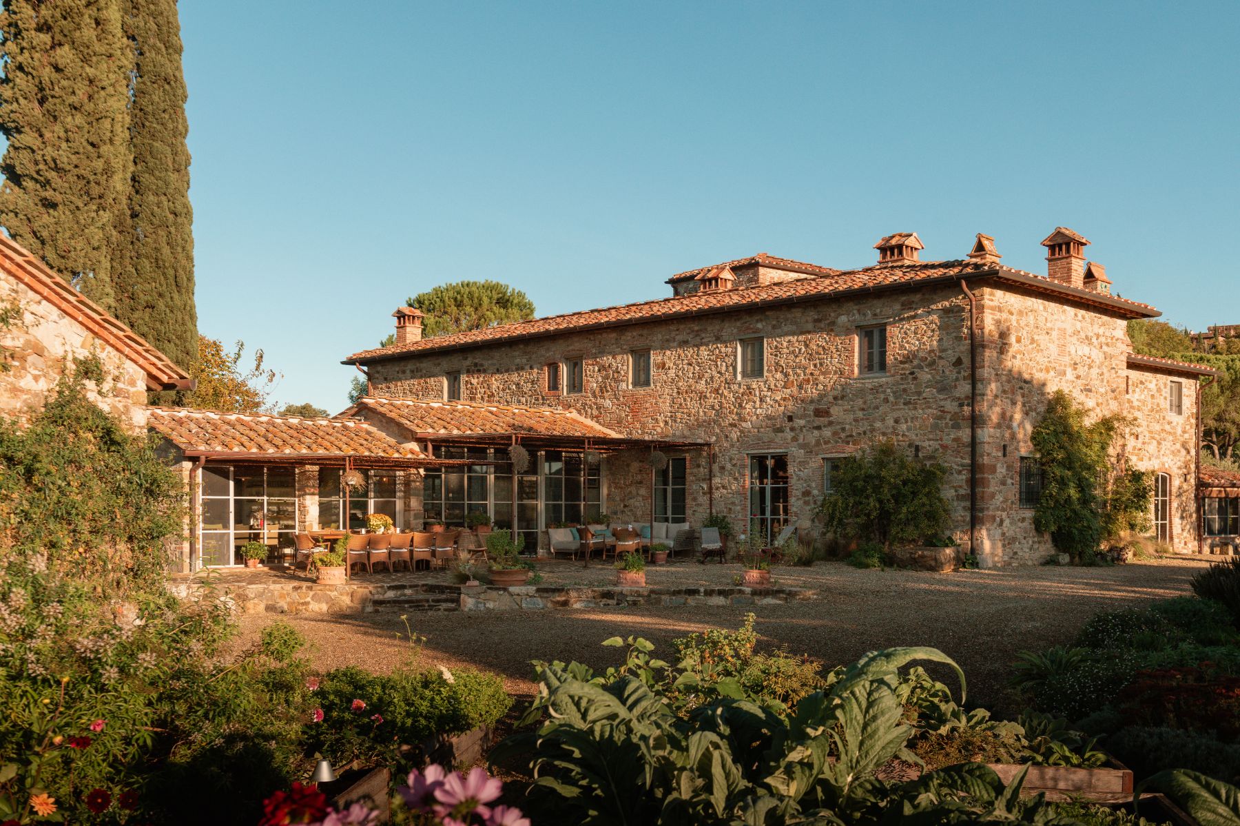 Main villa building at La Regina in Tuscany with view of the outdoor dining table
