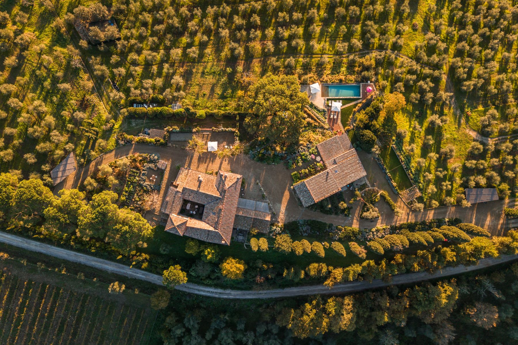 Overhead drone view of La Regina in Tuscany with view of the buildings and pool area