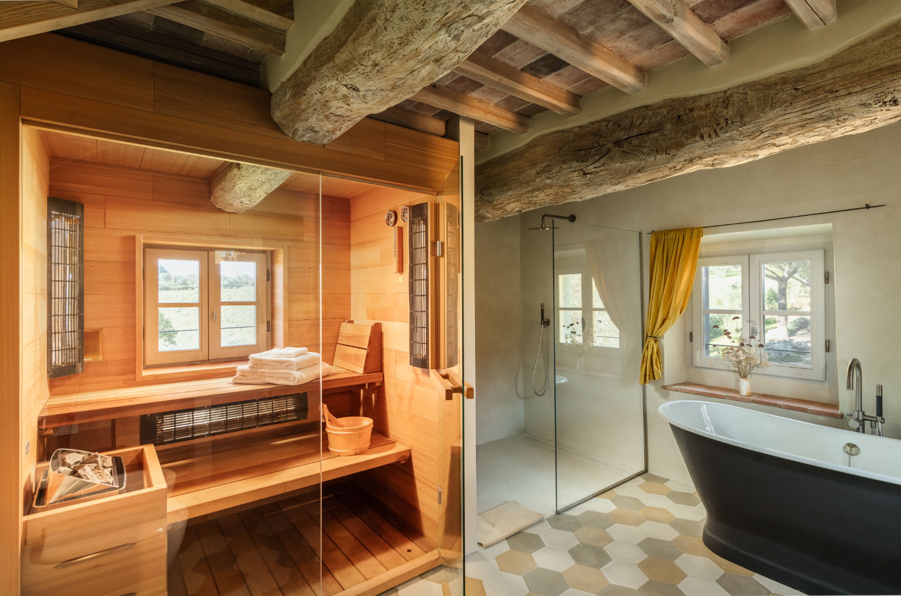 Bathroom with a bath tub and a sauna at La Regina in Tuscany