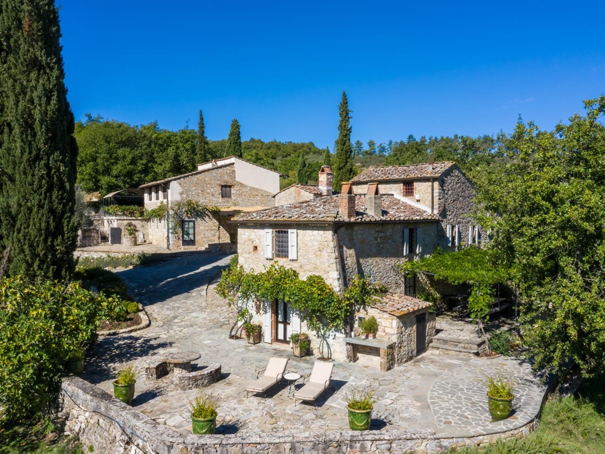 Exterior of the granary surrounded by trees at la tenuta, tuscany