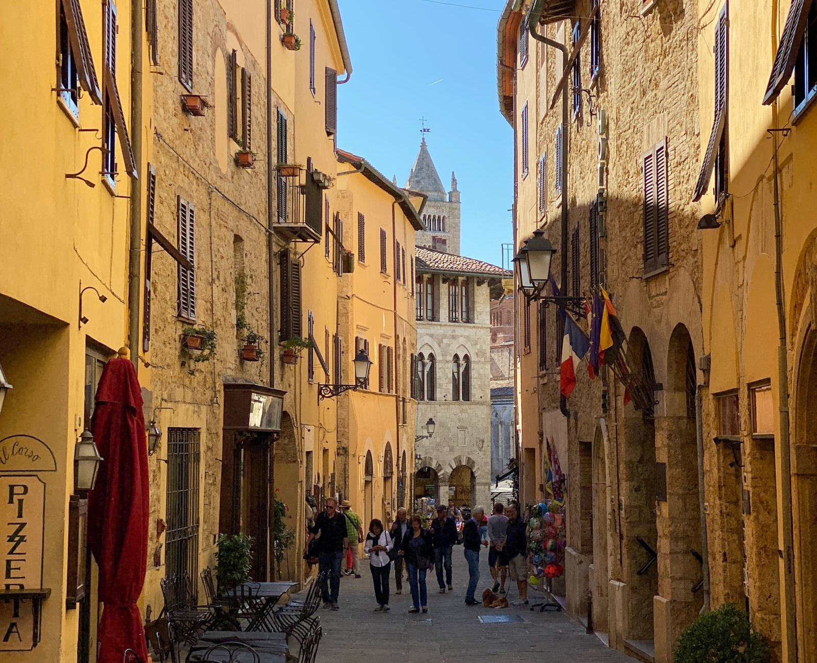Colourful street with shops and cafés in Massa Marittima near La Vigna in Tuscany, Italy