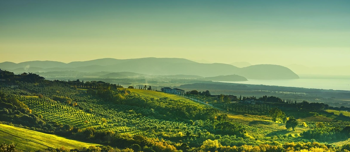 A landscape shot of Maremma in Southern Tuscany with the sea and mountains in the background