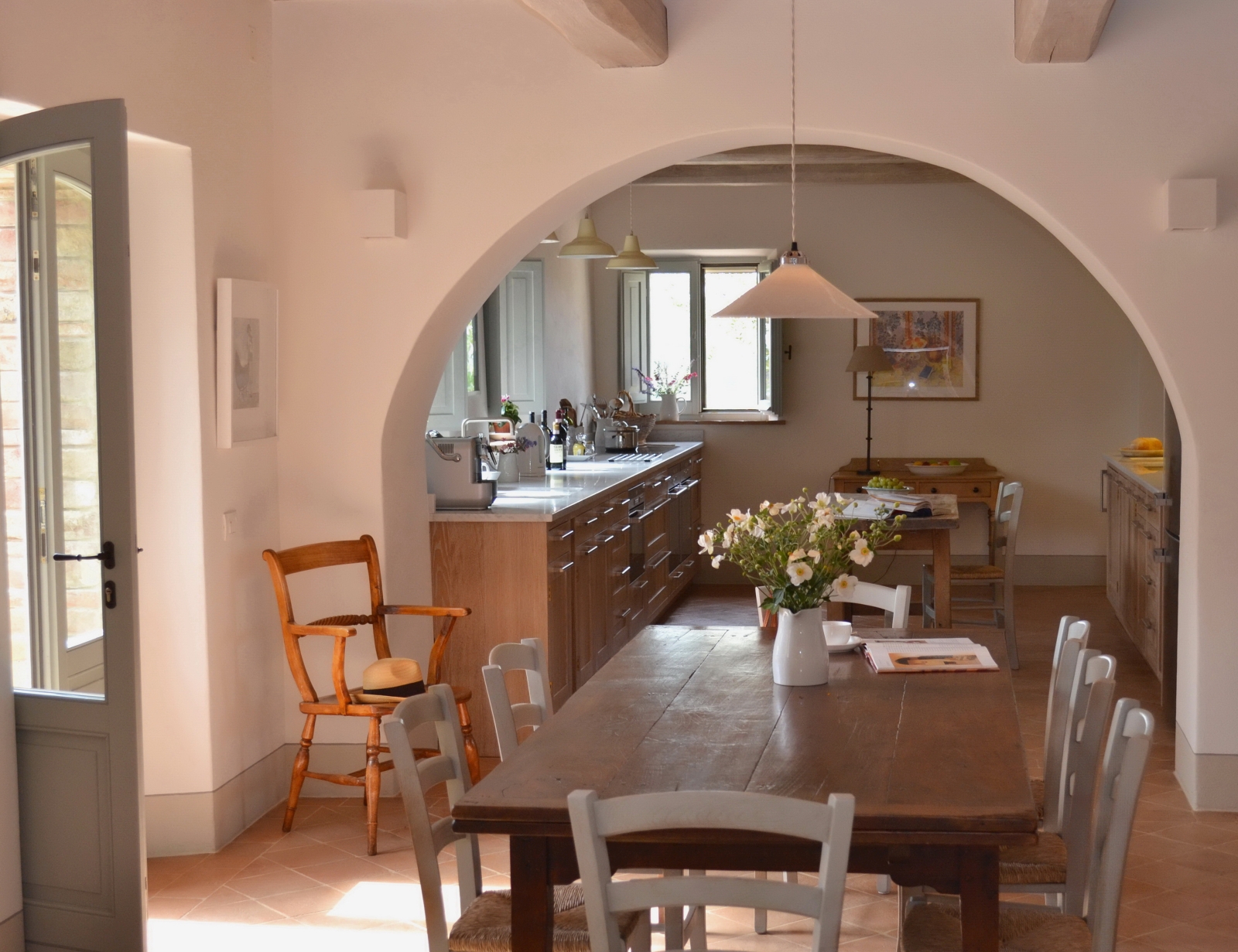 Dining table with vase of flowers at Podere Caterina in Tuscany